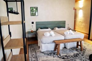 a bedroom with a bed, chair, and table in it at Santa Brigida - Real 1 in Hontanas