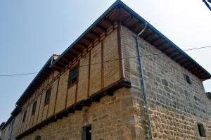 a tall brick building with windows on it at Santa Brigida - Real 1 in Hontanas