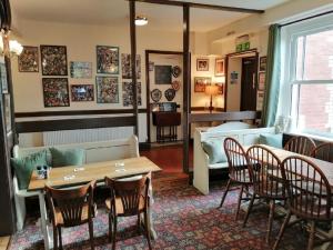 a living room with a table and chairs and a couch at Lion Hotel in Llanbister