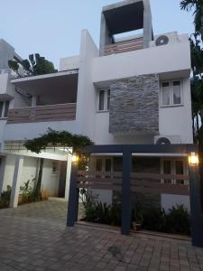 a house with a driveway in front of it at Avuraa Hospitality India in Chennai
