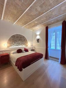 a bedroom with a large bed with a stone wall at Domus Avi - Guest House in Rome