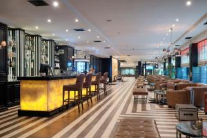 a bar in a restaurant with chairs and tables at Grand Hotel Bansko - Fitness & SPA in Bansko