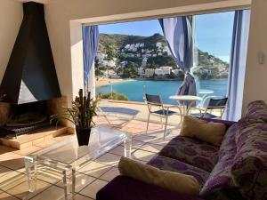 a living room with a couch and a view of the ocean at Montemar in Roses