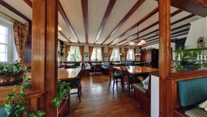 a dining room with wooden tables and chairs at Hotel Gasthof Lachner in Stetten