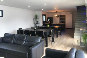 a living room with a couch and a table and chairs at Villa Charles & Ashton in Sarzeau +27 photos