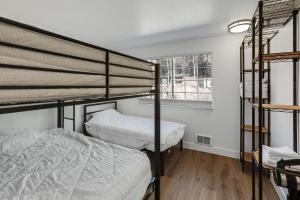 two bunk beds in a room with a window at Beautiful Ski-in Ski-out Condo Located On The Eagle Point Resort! condo in Beaver