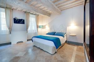 Säng eller sängar i ett rum på Palazzo Pio III - Residenza d'epoca