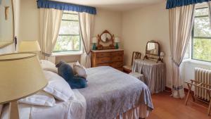 a bedroom with a bed with two pillows on it at Antica Fattoria La Parrina in Orbetello