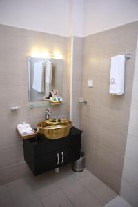 a bathroom with a wooden sink and a mirror at Swat Palace Hotel By Northin in Mām Derai
