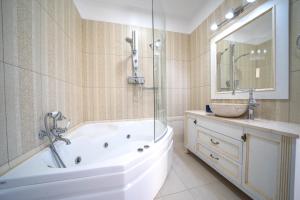 a white bathroom with a tub and a sink at Iremia Luxury Villa with pool in  Episkopi (Chania)