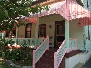 a porch of a house with a pink and green railing at Great Location! 4 Bedroom 2 bath sleeps 10 in Cape May