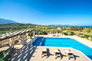 a villa with a swimming pool and a view of the ocean at Iremia Luxury Villa with pool in  Episkopi (Chania)