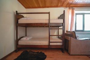 a bunk bed with two bunk beds in a room at Гостевой дом "Салта" in Gunib