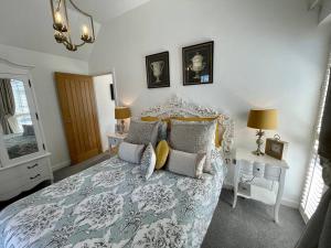 a bedroom with a bed with a blue and white comforter at Salt Yard Cottage No 1 in Whitstable