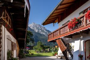 a view of a mountain from between two buildings at Gästehaus Hinterponholz in Ramsau