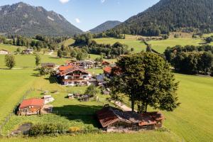 a village in the middle of a green field at Gästehaus Hinterponholz in Ramsau