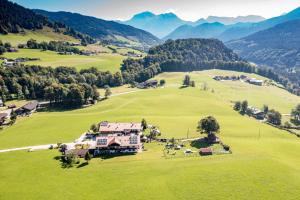 an aerial view of a house in a green field at Gästehaus Hinterponholz in Ramsau