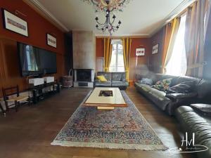 a living room with a couch and a coffee table at La demeure des tisserands in La Bresse