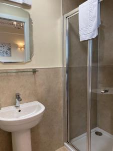 a bathroom with a sink and a shower at Ardross Glencairn in Inverness