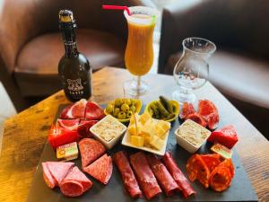 a tray of different types of food and a bottle of beer at Contact hôtel - Motel Les Bleuets in Honfleur