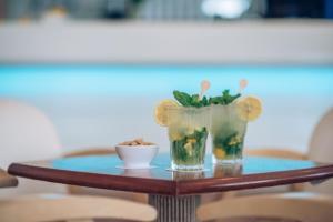 a table with two glasses and a bowl on it at Iberostar Waves Las Dalias All Inclusive in Adeje