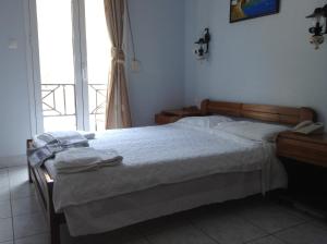 Ένα ή περισσότερα κρεβάτια σε δωμάτιο στο Hotel Asteria