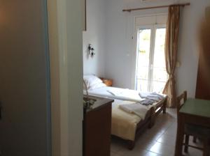 En eller flere senge i et værelse på Hotel Asteria