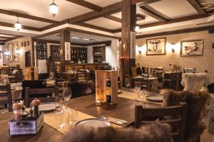 a restaurant with a wooden table and chairs and tables and tablesktop at Mentor Resort in Gaytaninovo