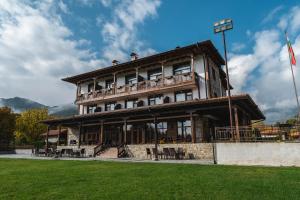 a large building with a balcony on top of it at Mentor Resort in Gaytaninovo