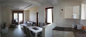 a kitchen with a counter and a table in it at Apartments Admiral in Herceg-Novi