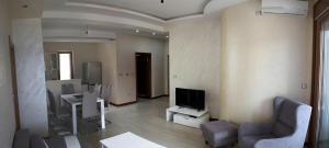 a living room with a couch and a television at Apartments Admiral in Herceg-Novi