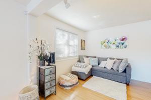 a living room with a gray couch and a window at Heavenly Lakefront in Plymouth