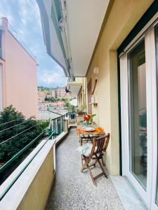 a balcony with a table and chairs on a building at Dimora Concept - Casa Leon - Bike room in Finale Ligure