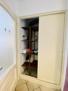 a closet with a door open in a kitchen at Dimora Concept - Casa Leon - Bike room in Finale Ligure