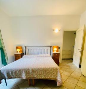 a bedroom with a bed and two night stands at Dimora Concept - Casa Leon - Bike room in Finale Ligure +18 photos