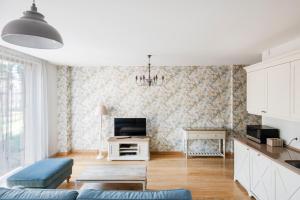 a living room with a couch and a tv at SoulHouse apartments in Druskininkai