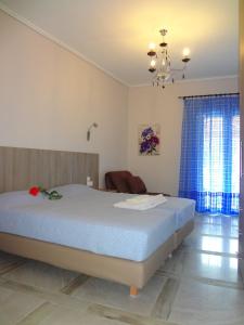 a bedroom with a large bed and a chandelier at Nidri Zone in Nydri