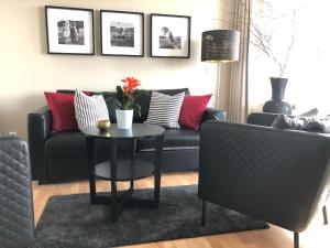 a living room with a couch and a table at Sehnsucht Rügen Ferienappartements in Ostseebad Sellin