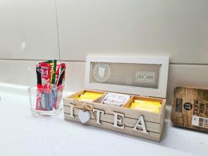 a wooden box filled with different types of pencils at Apartman City in Bijeljina