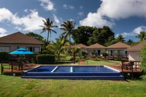 a resort with a swimming pool and some houses at Pousada Lua Bela in Fernando de Noronha