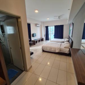 a hotel room with a bed and a bathroom at KK Aeropod Corner unit A near Airport and City Free Parking in Kota Kinabalu