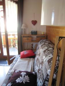 a bedroom with a bed and a dresser and a window at Appartement d'une chambre a Bernex a 50 m des pistes avec balcon et wifi in Bernex