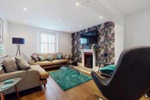 a living room with a couch and a fireplace at 21 Cross Street in Lynton