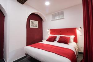 a bedroom with a red headboard and a white bed at Charming Large Apartment - 3 Bedroom in Trastevere in Rome