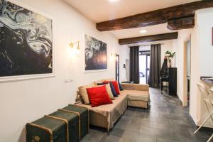 a living room with a couch and red pillows at Charming Large Apartment - 3 Bedroom in Trastevere in Rome