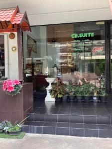 a store front of a store with plants in the window at CR.HOTEL in Makkasan