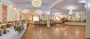 a banquet hall with tables and chairs in a room at Piastun SPA&Wellness Krynica-Zdrój in Krynica Zdrój +136 photos