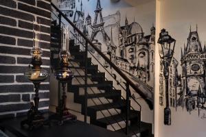 a stairway with a mural offamousfamous buildings at Hotel Shato Gesson in Prague