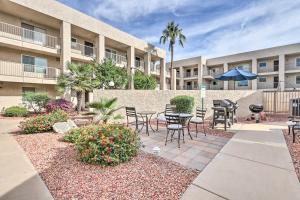 a patio with chairs and tables in front of a building at 1 Mi to Old Town Scottsdale Condo with Pool Access in Scottsdale