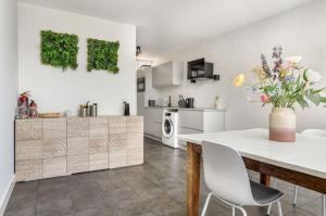 una cucina e una sala da pranzo con tavolo e sedie di Silt14 Sfeervol vakantie appartement a Noordwijk